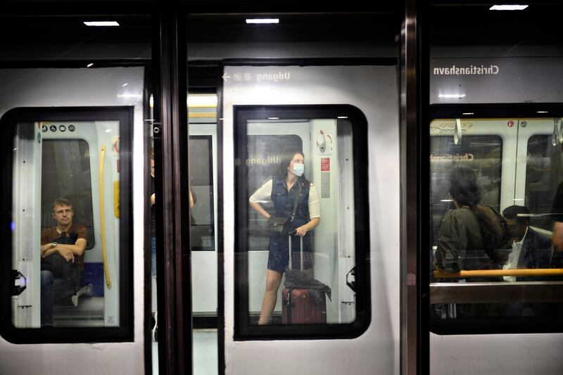 Commuters keep social distancing inside an underground train in Copenhagen, Denmark. EPA