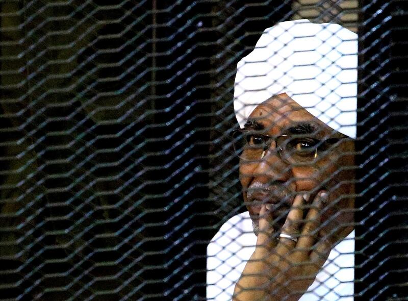 FILE PHOTO: Sudan's former president Omar Hassan al-Bashir sits inside a cage at the courthouse where he is facing corruption charges, in Khartoum, Sudan September 28, 2019. REUTERS/Mohamed Nureldin Abdallah/File Photo