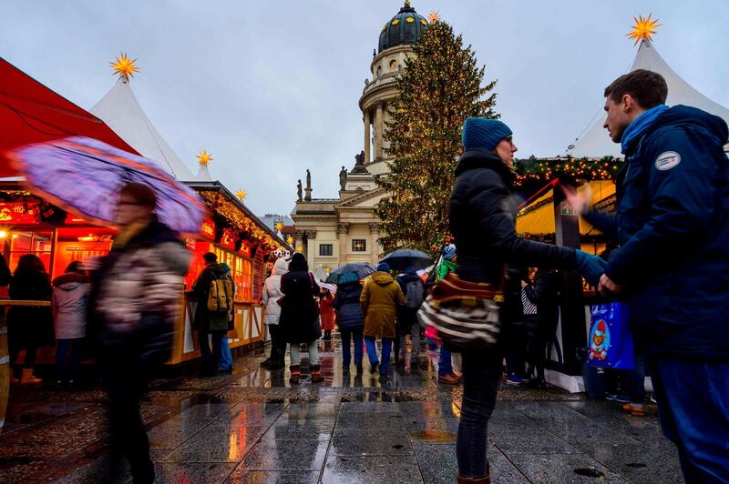 People visit a Christmas market in the Gendarmenmarkt ahead of the holiday season in Berlin.  AFP