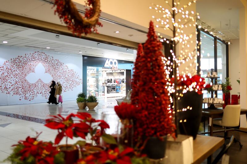 Red Christmas trees in the window display of a home store in Riyadh, Saudi Arabia.  Bloomberg