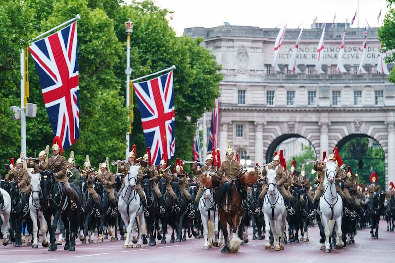 Troops of the Household Cavalry march on The Mall in central London. PA