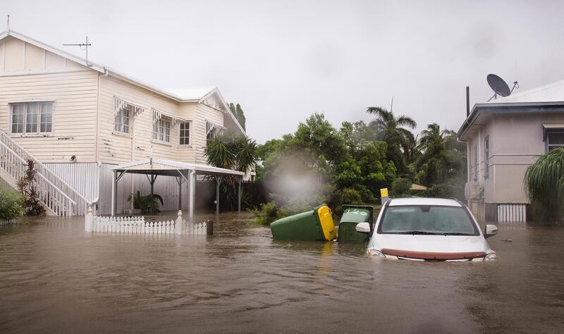 A semi-submerged car outside a home in Rosslea, Townsville following days of heavy monsoonal rains.  EPA
