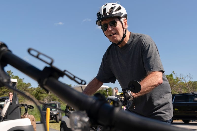 Finally, back on his bike, Mr Biden rode off into the sunset. AP