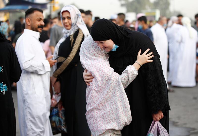 Muslims greet each other after prayers on the first day of Eid al-Fitr holiday outside Abu Hanifa mosque in Baghdad, Iraq. AP Photo