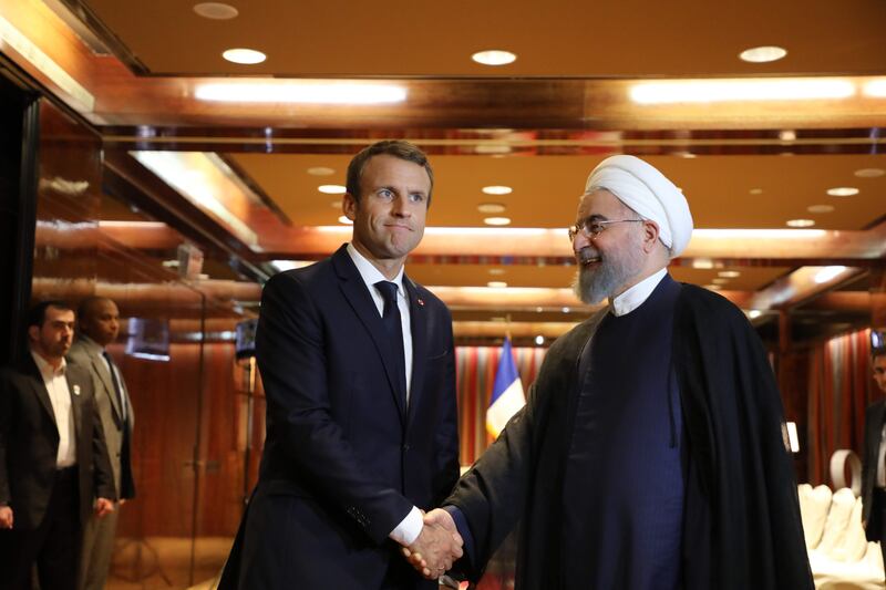 France's president Emmanuel Macron (L) greets Iranian president Hassan Rouhani at the Millennium Hotel near the United Nations on September 18, 2017, in New York. / AFP PHOTO / LUDOVIC MARIN