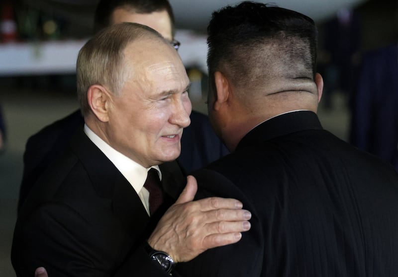Mr Putin embraces his North Korean host. EPA / Sputnik / Kremlin pool