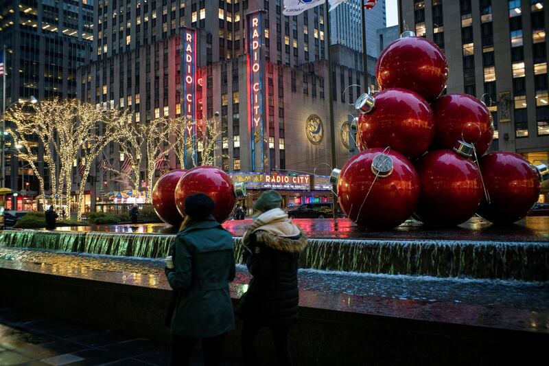 People walk around Christmas decorations  as the global outbreak of the coronavirus disease (COVID-19) continues, in New York City, U.S., December 9, 2020. REUTERS/Eduardo Munoz
