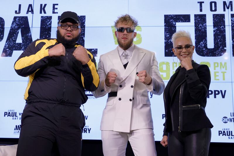 Comedian Drew "Druski" Desbordes as "Coach D," Jake Paul and Showtime boxing host Claudia Trejos pose. AFP