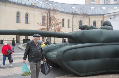 Ukrainians walk past inflatable tanks near a metro station in Kiev, Ukraine, December 16. EPA