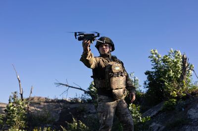 A Ukrainian serviceman known as "Beha" of "Code 9. 2" launches a drone before flying over Russian positions at the frontline near Klishchiivka, Donetsk region, Ukraine, Sunday, Sept.  24, 2023. (AP Photo/Alex Babenko). 