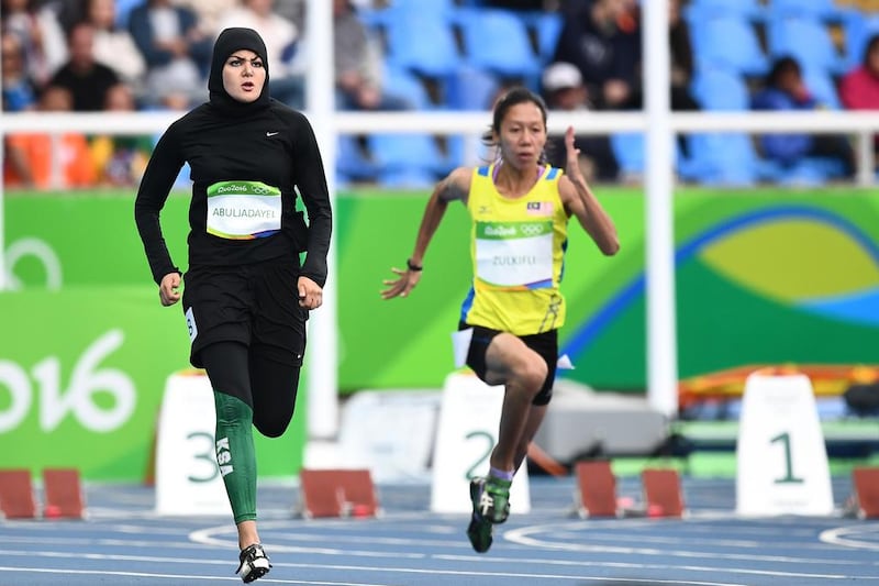 Saudi Arabia's Kariman Abuljadayel and Malaysia's Zaidatul Husniah Zulkifli compete in the women's 100m preliminary round at Rio. Jewel Samad / AFP