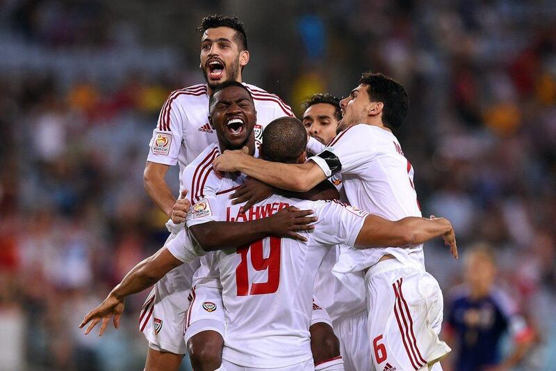 UAE players celebrate after winning the penalty shootout against Japan on Friday in the Asian Cup quarter-finals. They will face Australia in the semi-finals on Tuesday. Paul Miller / EPA