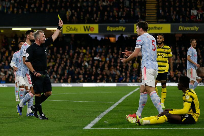 United's Harry Maguire is shown his first yellow card. AFP