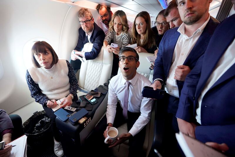 Rishi Sunak holds a huddle with political journalists on board a government plane as he heads to Washington. Reuters