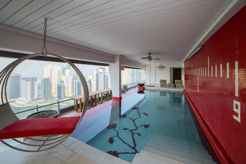 The pool area boasts bold red tiles and marina views. Courtesy Allsopp & Allsopp