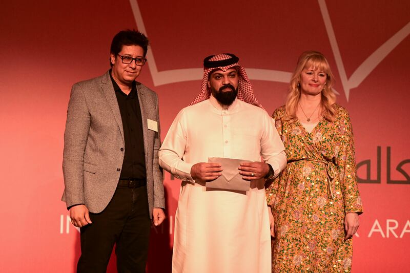 A representative accepts the award on behalf of Mohammed Alnaas, Libyan writer and winner of the International Prize for Arabic Fiction 2022. Alnaas, the youngest winner in the award's history, receives $50,000.