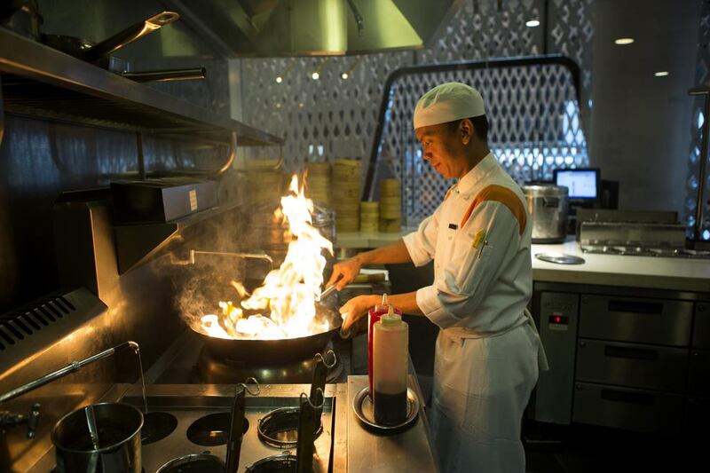 A chef prepares the kitchen of the Noodle Box restaurant before dinner at the Yas Viceroy Hotel in Abu Dhabi. Christopher Pike / The National