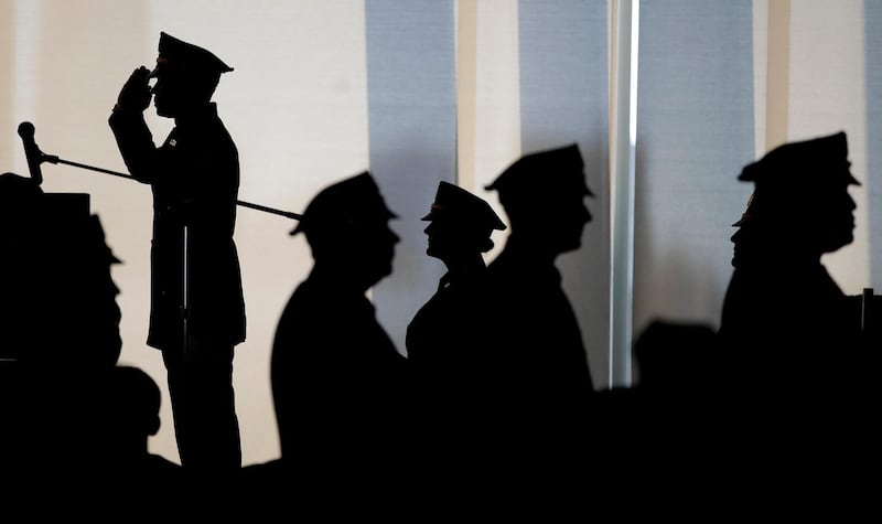 Jean Charlot, an officer with the Port Authority of New York and New Jersey Police Department, salutes as he is introduced on stage during a ceremony promoting him to his new rank as sergeant. Julio Cortez / AP Photo