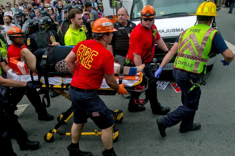 
                  An injured person is taken away by Emergency Medical Services workers after a car ran into pedestrians during a white nationalist rally, Saturday Aug. 12, 2017, in Charlottesville, Va. (Shaban Athuman/Richmond Times-Dispatch via AP)
               