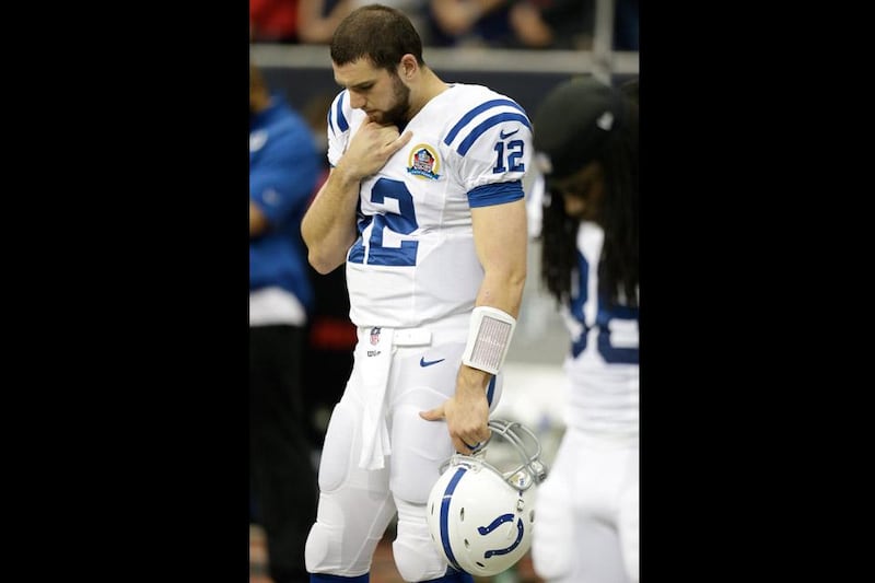 Indianapolis Colts quarterback Andrew Luck bows his head during a moment of silence for the victims of the Sandy Hook Elementary School shootings before an NFL football game against the Houston Texans. Eric Gay / AP Photo