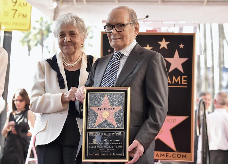 HOLLYWOOD, CA - FEBRUARY 26: Maria Travia and composer Ennio Morricone attend a ceremony honoring Ennio Morricone with the 2,575th Star on The Hollywood Walk of Fame on February 26, 2016 in Hollywood, California.   Alberto E. Rodriguez/Getty Images/AFP