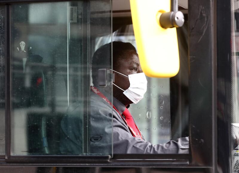 A bus driver wearing a face mask is seen, as the spread of the coronavirus disease (COVID-19) continues, London, Britain. REUTERS