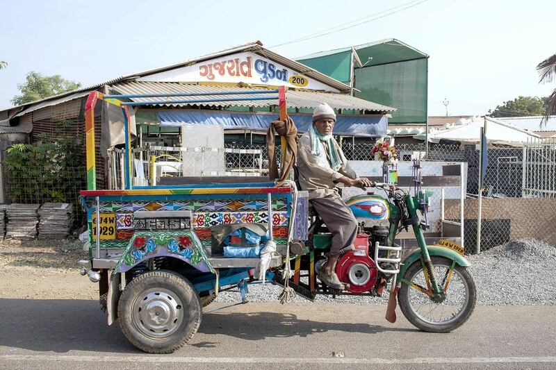 These three-wheeled lorries used to ferry workers but now find fewer customers as the numbers of workers employed in yards has gone down. Subhash Sharma for The National