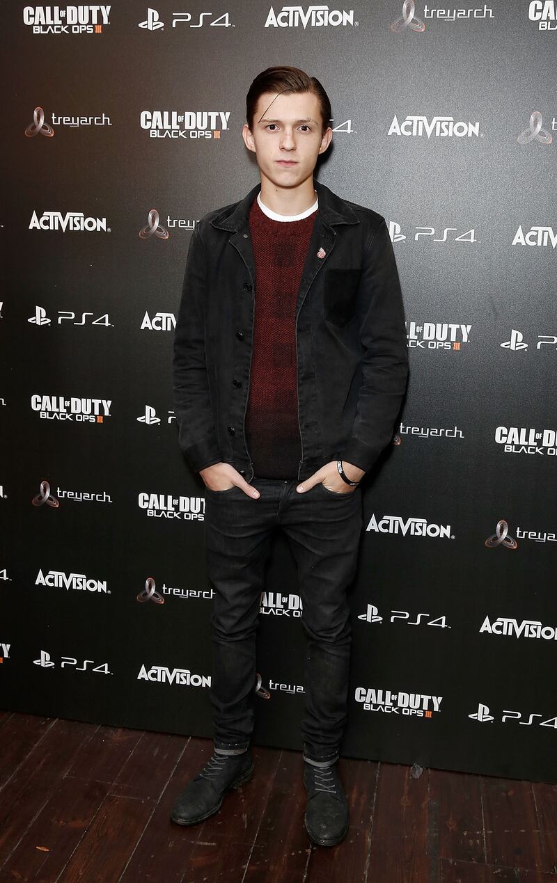 Tom Holland, in a red jumper and black jacket, attends the 'Call of Duty Black Ops III' launch on November 5, 2015 in London. Getty Images