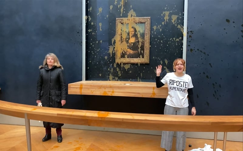 Two climate activists have thrown soup at the Mona Lisa painting in Paris. Photo: David Cantiniaux / AFP