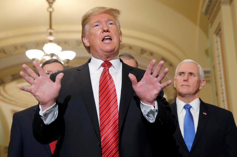 FILE PHOTO: U.S. President Donald Trump talks to reporters as Vice President Mike Pence looks on as the president departs after addressing a closed Senate Republican policy lunch while a partial government shutdown enters its 19th day on Capitol Hill in Washington, U.S., January 9, 2019. REUTERS/Jim Young/File Photo