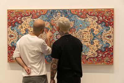 Nabavi and Seife examine the work titled Tenet by Seife. Antonie Robertson / The National