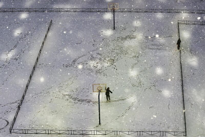 Boys play on a sports ground during a snowfall in Saint Petersburg, Russia. AFP