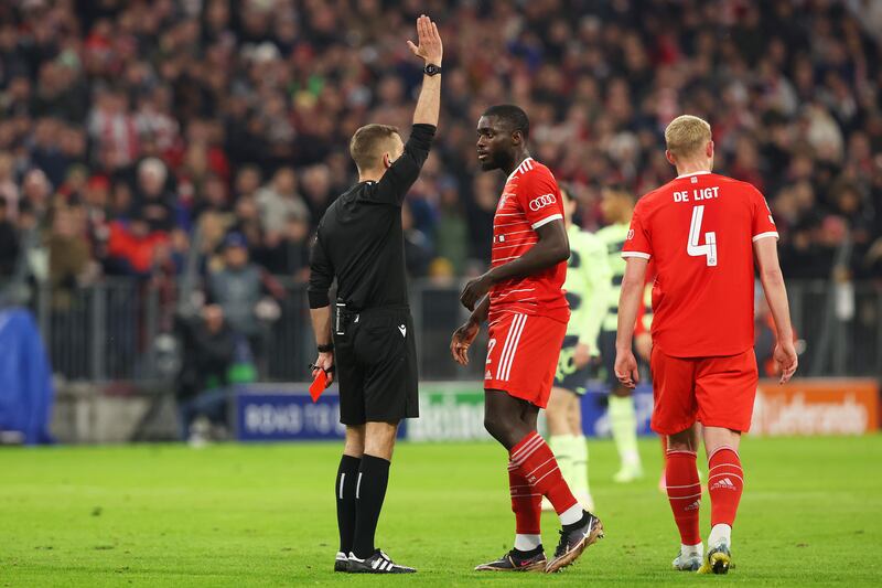 Referee Clement Turpin withdraws the red card shown to Bayern's Dayot Upamecano after a VAR review ruled there was an offside before he committed a foul on Erling Haaland. Getty 
