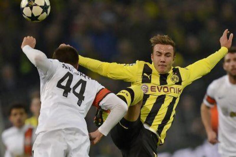 Mario Goetze, right, and his Dortmund teammates got past Shakhtar Donetsk on Tuesday. Martin Meissner / AP Photo