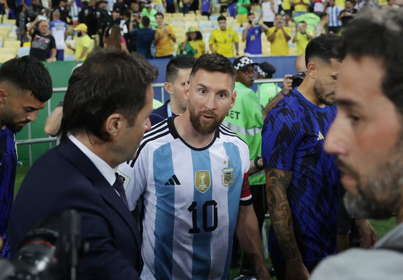 Lionel Messi in discussions with officials as the match is delayed because of crowd trouble. Reuters