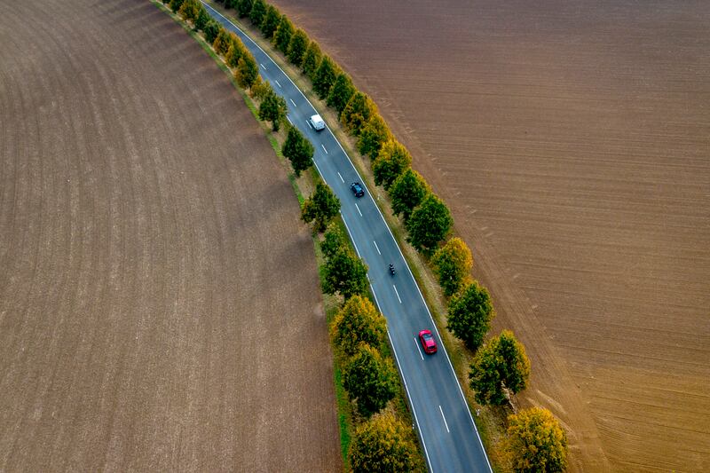 Cars drive through a road in the outskirts of Frankfurt, Germany. AP