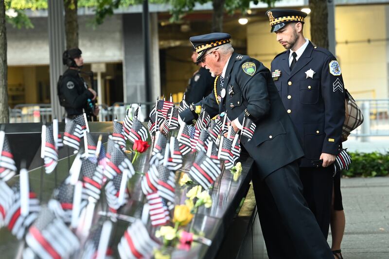 Retired Willow Springs, Illinois Chief of Police Sam Pulia and his nephew, Chicago Police Sgt Daniel Pulia, place flags at the South Tower ahead of ceremonies to mark the 20th anniversary of the 9/11 attacks. EPA