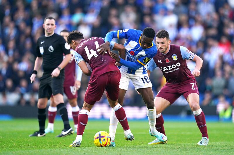 Brighton and Hove Albion's Danny Welbeck battles for the ball with Aston Villa's Boubacar Kamara and John McGinn.PA