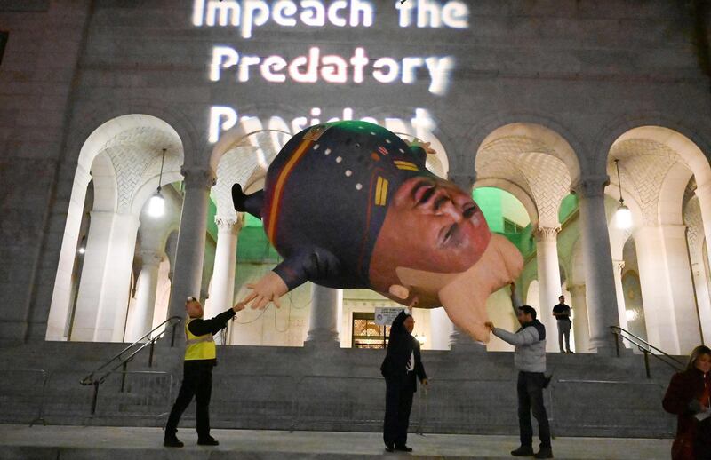 Protestors prepare to release a "Comrade Trump" balloon at a demonstration in support of the impeachment of US President Donald Trump in Los Angeles, California. AFP