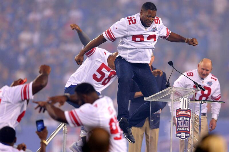 Former New York Giants players jump around during a half-time ceremony honouring the 2007 Super Bowl champions. Brad Penner-USA TODAY Sports