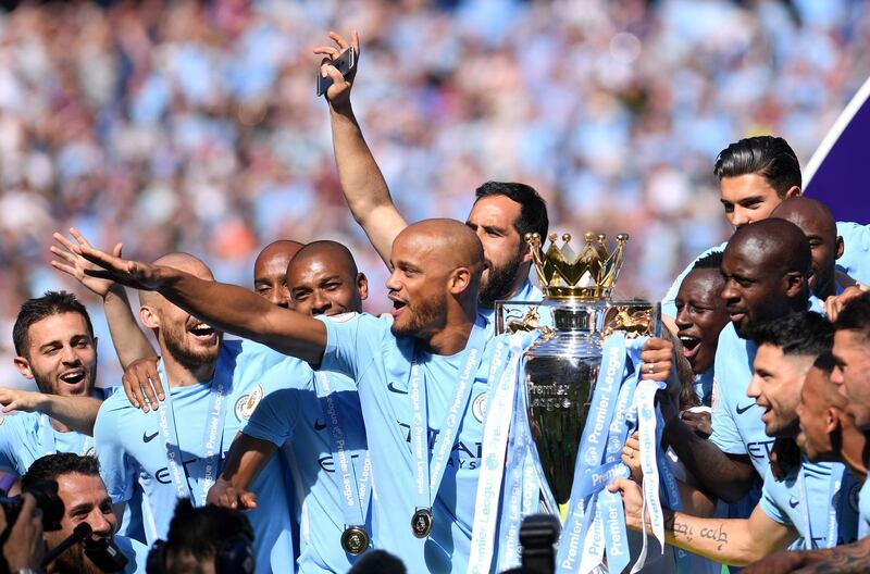 MANCHESTER, ENGLAND - MAY 06: Vincent Kompany of Manchester City celebrate with The Premier League Trophy after the Premier League match between Manchester City and Huddersfield Town at Etihad Stadium on May 6, 2018 in Manchester, England.  (Photo by Laurence Griffiths/Getty Images)