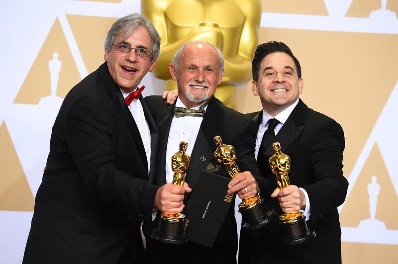 Mark Weingarten, from left, Gregg Landaker, and Gary Rizzo, winners of the award for best sound mixing for "Dunkirk", pose in the press room at the Oscars. Jordan Strauss / Invision /AP