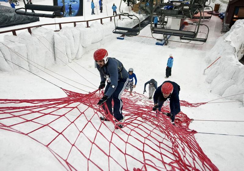 Contestants tackle obstacles in the Ice Warrior Challenge to raise money for charity at Ski Dubai. Charles Crowell / The National