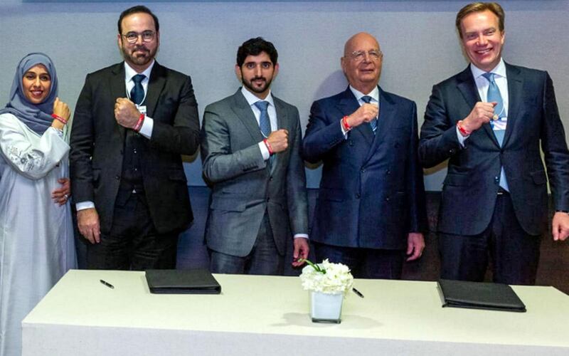 Sheikh Hamdan bin Mohammed, Crown Prince of Dubai, Mohammed Al Gergawi, Minister of Cabinet Affairs and The Future, Hessa Buhumaid, Minister of Community Development, and Klaus Schwab, executive chairman of the World Economic Forum, wear the Special Olympics red wrist band in Davos, Switzerland support of the World Games that will be held in Abu Dhabi in March. Courtesy Dubai Media Office