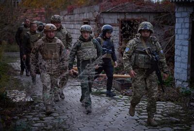 Ukrainian President Volodymyr Zelenskyy (C) surrounded by armed forces on a visit to Donetsk, eastern Ukraine. The area has been the focus of a war between Ukraine and Russian-backed separatists since 2014. AP