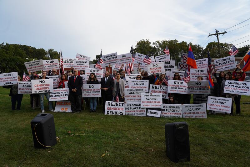 Protesters hold up signs against Dr Oz.