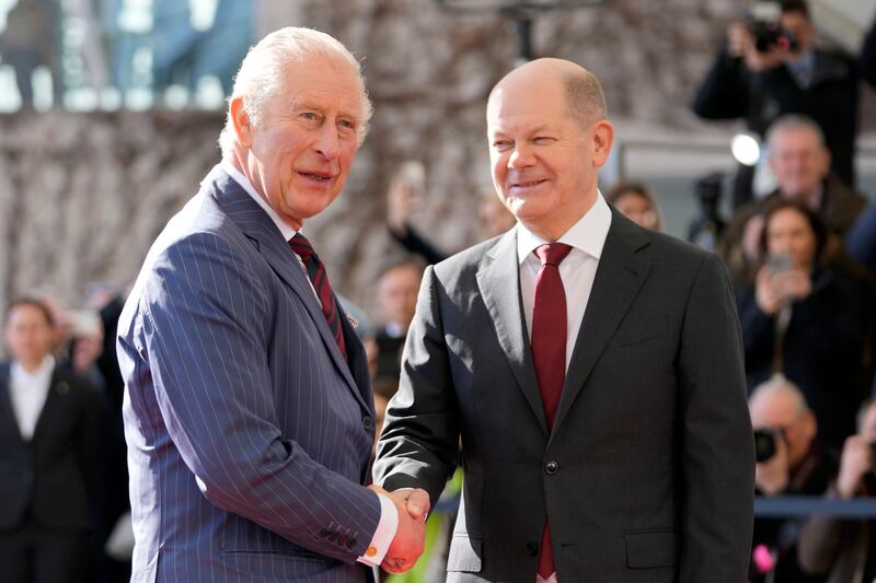 Mr Scholz welcomes King Charles in Berlin. AP