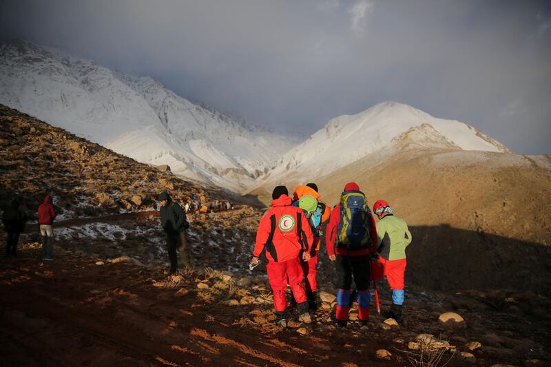 Members of emergency and rescue team search for the plane that crashed in a mountainous area of central Iran. Tasnim News Agency / Reuters