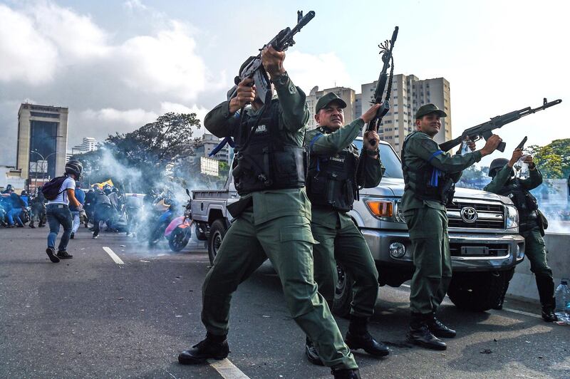 Members of the Bolivarian National Guard who joined Mr. Guaido fire into the air to repel forces loyal to Mr. Maduro. AFP