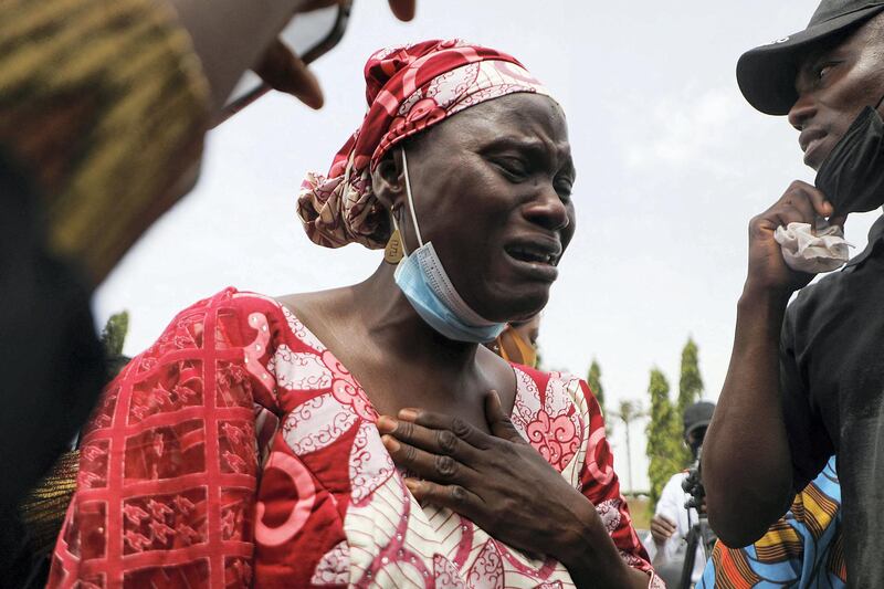 Rabi Magaji-Zakariah (C), a mother of one of the Federal College of Forestry Mechanization students who has been abducted, cries during a demonstration in Abuja on May 4, 2021 to demand the release of their families who has spent 55 days in captivity. - Gunmen raided a college in northwestern Nigeria and kidnapped at least 30 students, government officials and parents said on March 12, 2021, in the latest mass abduction targeting a school. (Photo by Kola Sulaimon / AFP)